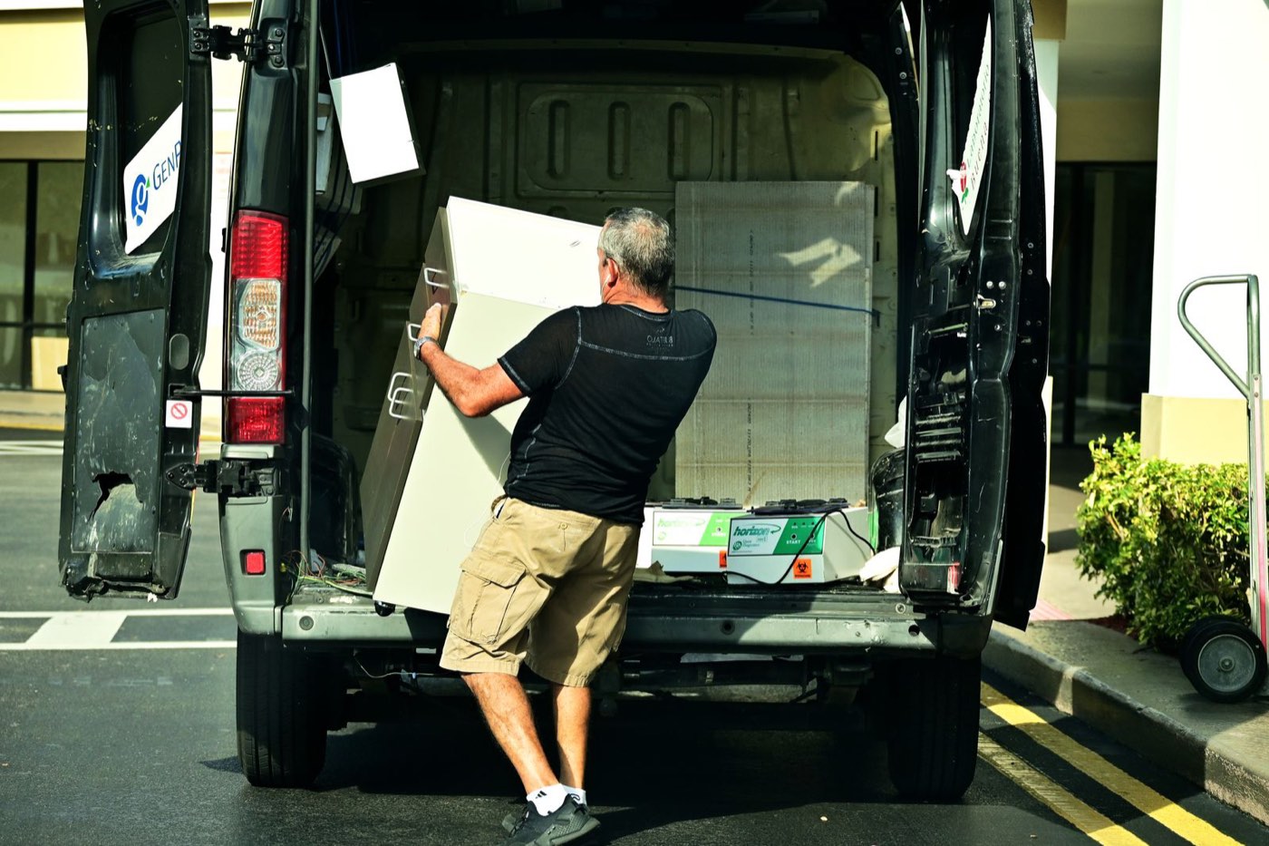 Furniture being loaded into the back of a van
