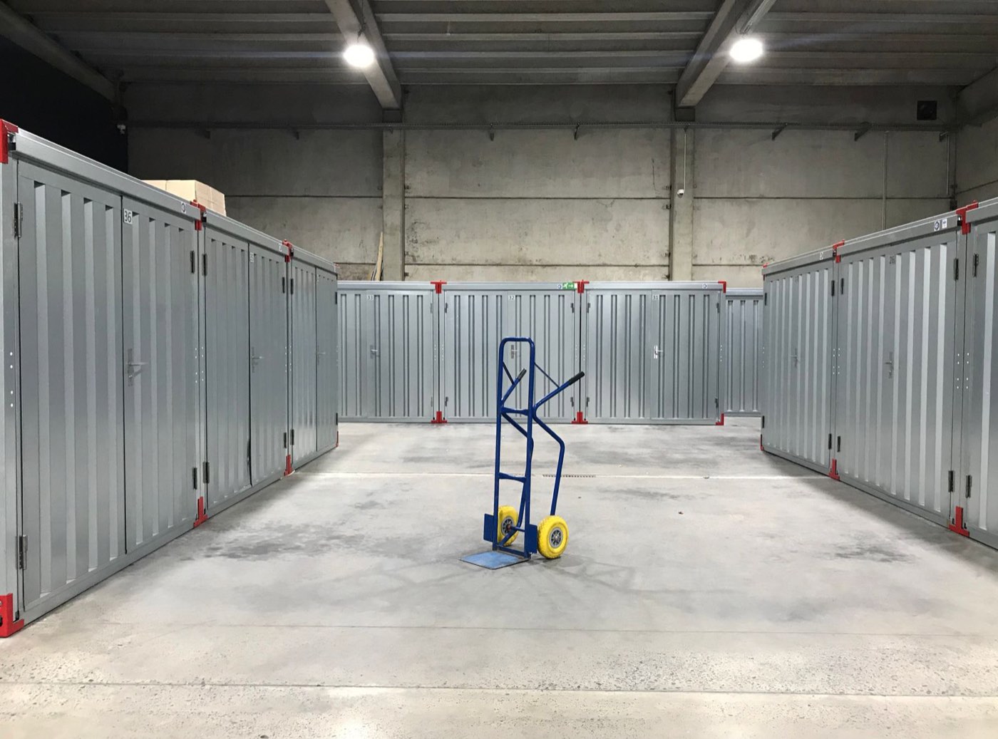 Rows of storage units with a hand truck in the aisle