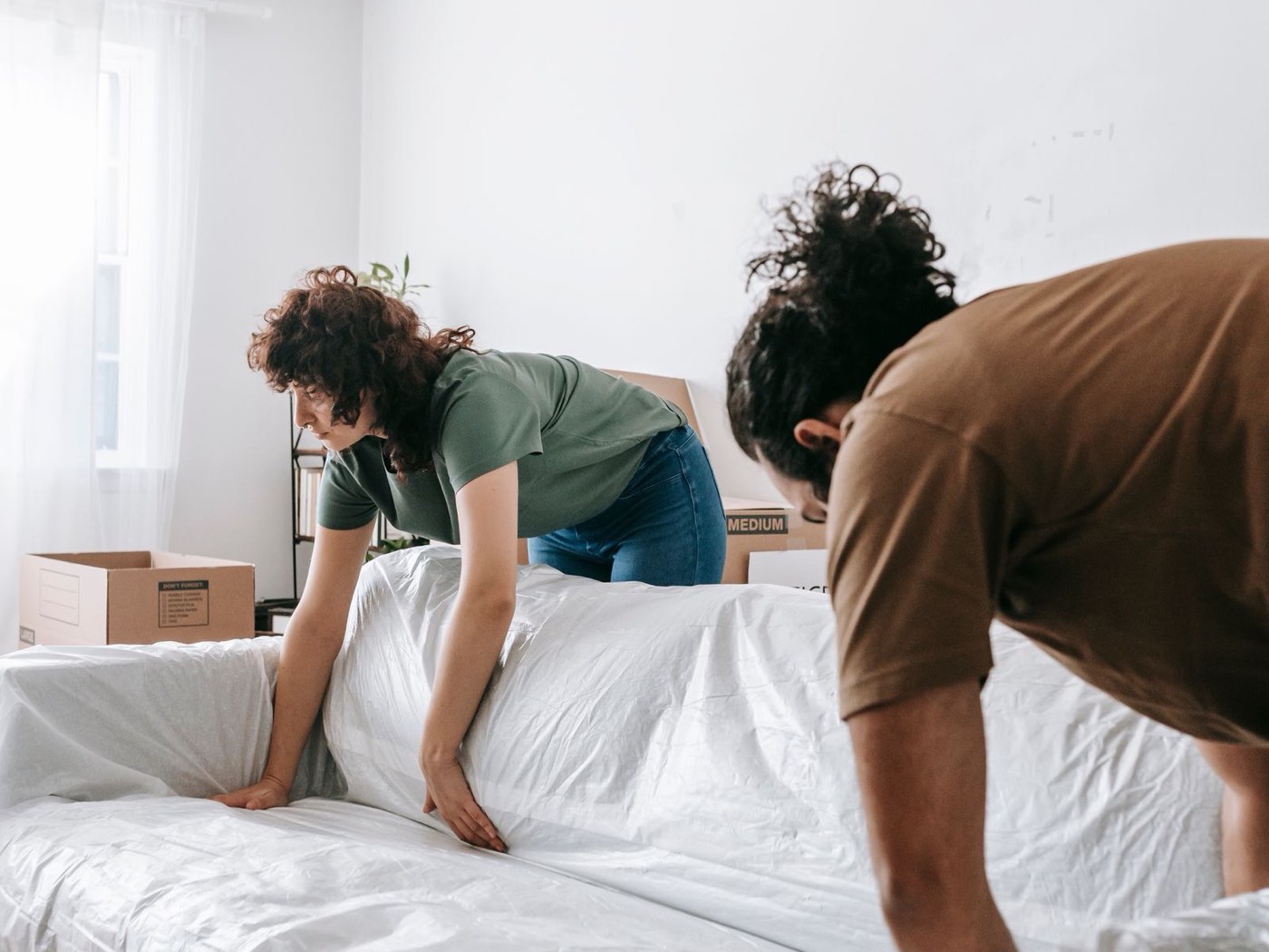 Wrapping a sofa in protective plastic before a move